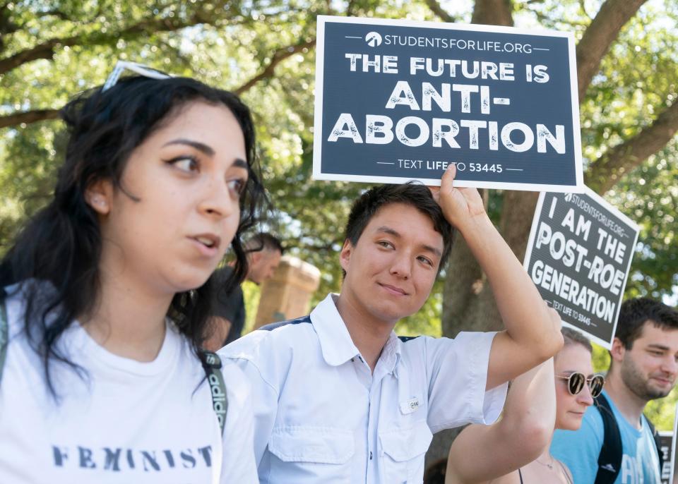 Jerry Sharp III of Austin holds a sign at Saturday's rally by abortion opponents.