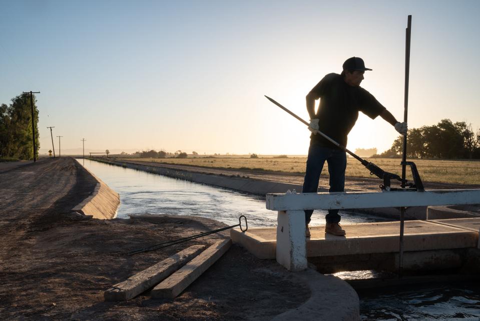 Jeff Dollente, a zanjero with the Imperial Irrigation District, opens a gate on the Redwood Canal north of El Centro, California, on June 1, 2022. Dollente moved 119-acre feet of water during his shift. The district enjoy’s the largest share of any on the Colorado, and the majority of California’s allocation.
