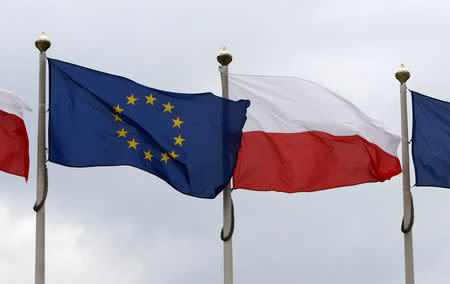FILE PHOTO - The flags of Poland and European Union flutter in front of the Polish parliament in Warsaw June 29, 2011. REUTERS/Kacper Pempel
