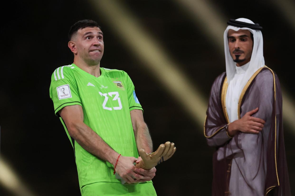 Emiliano Martinez, goalkeeper of Argentina, holds his golden glove trophy during the awarding ceremony of the 2022 FIFA World Cup at Lusail Stadium in Lusail, Qatar, Dec. 18, 2022. (Photo by Cao Can/Xinhua via Getty Images)