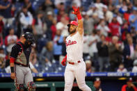 Philadelphia Phillies' Bryce Harper, right, reacts past Washington Nationals catcher Yan Gomes after hitting a home run off pitcher Max Scherzer during the second inning of a baseball game, Tuesday, June 22, 2021, in Philadelphia. (AP Photo/Matt Slocum)