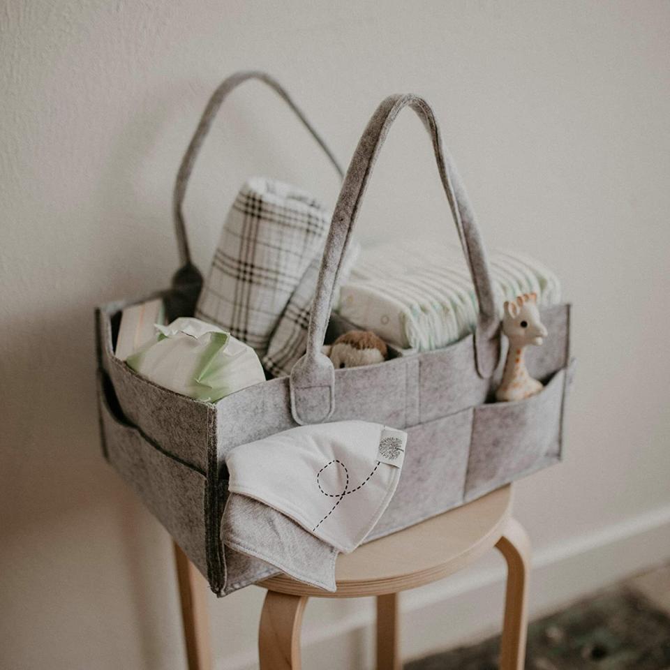 Designed with adjustable pockets, you'll be able to fit everything you need in a neat, orderly and travel-friendly fashion.<br /><br /><strong>Promising review:</strong> "This caddy is great! I ordered the larger size and it holds a ton of stuff. I use it daily to carry my daughter's diapers and other changing essentials from upstairs to downstairs. It's sturdy, spacious, and has a simple, attractive design which is exactly what I wanted. There are three small pockets and two large pockets on the sides of the caddy. <strong>The inside separator is detachable so you can arrange the sections however works best for you.</strong> The handles are a nice length &mdash; it's very easy to pick up. <strong>This is one of my favorite baby purchases I've made and I highly recommend it</strong>." &mdash; <a href="https://amzn.to/3aeIW4k" target="_blank" rel="nofollow noopener noreferrer" data-skimlinks-tracking="5902331" data-vars-affiliate="Amazon" data-vars-href="https://www.amazon.com/gp/customer-reviews/RWJWYYFFR8I12?tag=bfmal-20&amp;ascsubtag=5902331%2C11%2C37%2Cmobile_web%2C0%2C0%2C16540723" data-vars-keywords="cleaning,fast fashion" data-vars-link-id="16540723" data-vars-price="" data-vars-product-id="20969690" data-vars-product-img="" data-vars-product-title="" data-vars-retailers="Amazon">Zoe</a><br /><br /><strong>Get it from Amazon for <a href="https://amzn.to/3sl10Qr" target="_blank" rel="nofollow noopener noreferrer" data-skimlinks-tracking="5902331" data-vars-affiliate="Amazon" data-vars-asin="B075JS5R1J" data-vars-href="https://www.amazon.com/dp/B075JS5R1J?tag=bfmal-20&amp;ascsubtag=5902331%2C11%2C37%2Cmobile_web%2C0%2C0%2C16540692" data-vars-keywords="cleaning,fast fashion" data-vars-link-id="16540692" data-vars-price="" data-vars-product-id="18323843" data-vars-product-img="https://m.media-amazon.com/images/I/41rYnjpMxvL._SL500_.jpg" data-vars-product-title="Parker Baby Diaper Caddy - Nursery Storage Bin and Car Organizer for Diapers and Baby Wipes - Large" data-vars-retailers="Amazon">$19.95+</a> (available in two sizes).</strong>