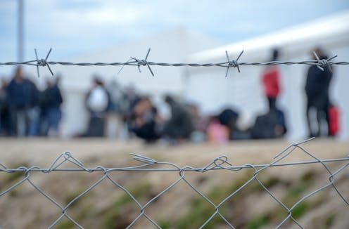 <span class="attribution"><a class="link " href="https://www.shutterstock.com/image-photo/barbed-wire-refugee-camp-migrants-behind-1880589040" rel="nofollow noopener" target="_blank" data-ylk="slk:Ajdin Kamber/Shutterstock;elm:context_link;itc:0;sec:content-canvas">Ajdin Kamber/Shutterstock</a></span>