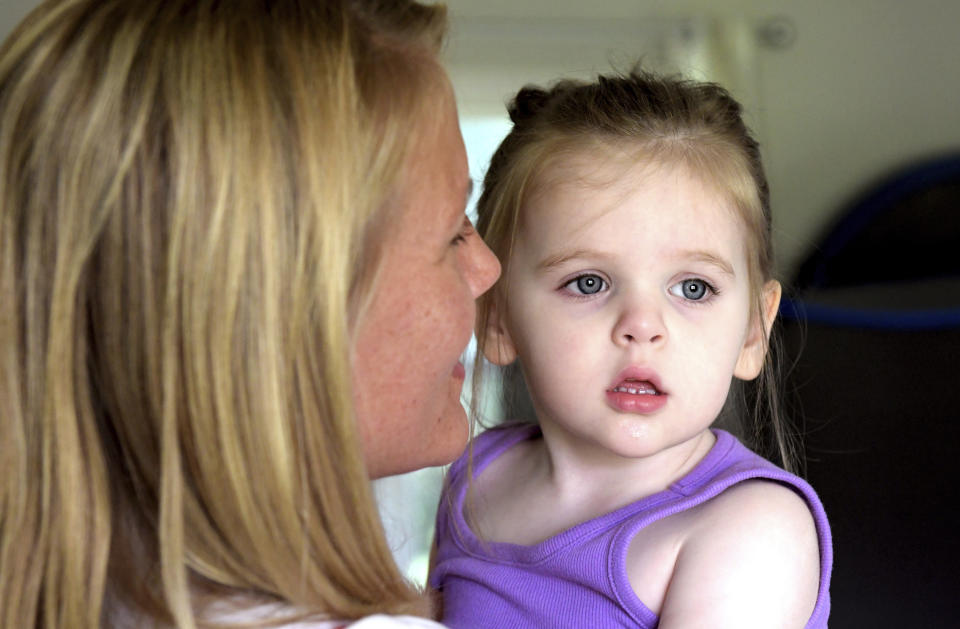 Early Intervention speech pathologist Megan Sanders works with 2-year-old Aria Faulkner at parents Lindsey and Kendrick Faulkner's home in Peoria, Ill., Aug. 15, 2023. (AP Photo/Ron Johnson)