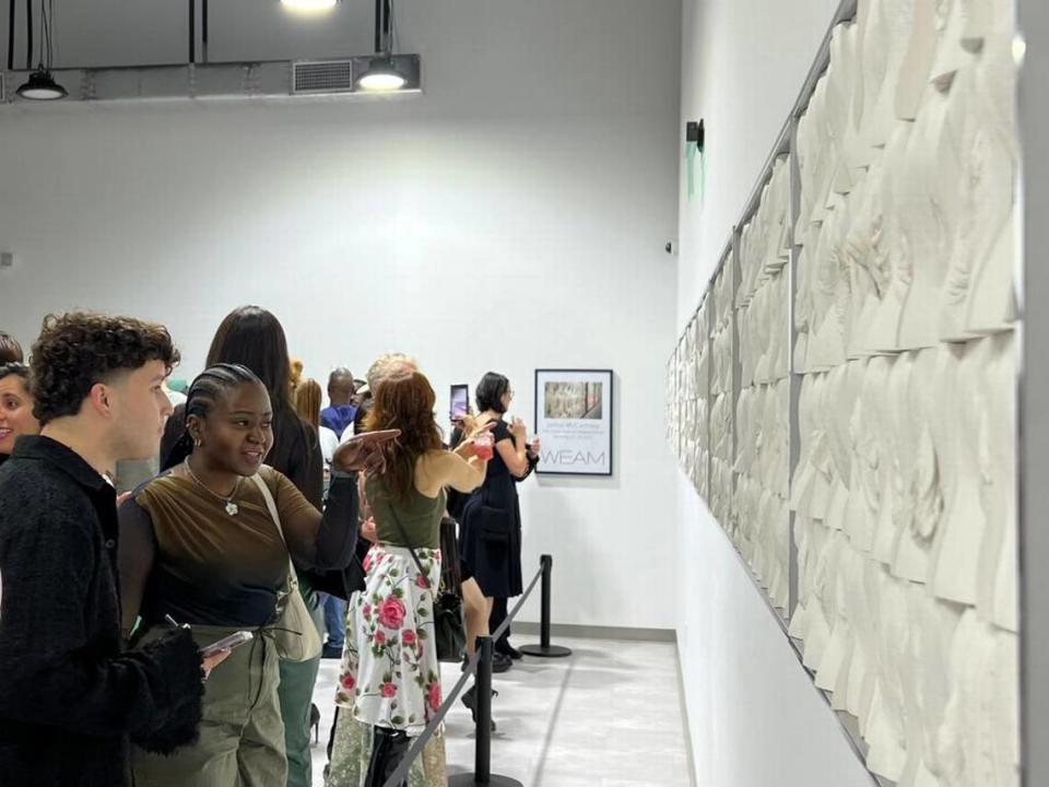 Visitors at the Wilzig Erotic Art Museum in Miami Beach examine artist Jamie McCartney’s “The Great Wall of Vulva” at the opening of the show during Miami Art Week.