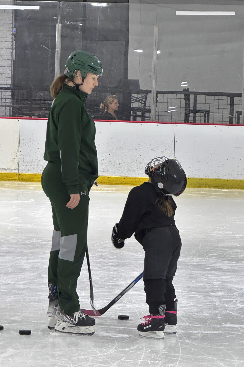 Lyndsey Fry coaches during an Arizona Kachinas hockey practice at Arizona Made Ice Forum in Mesa, Ariz., May 1, 2024. The 2014 Olympian has created the Matt Shott Arizona Hockey Legacy Foundation to support boys and girls hockey programs after the Arizona Coyotes moved to Utah. (AP Photo/John Marshall)