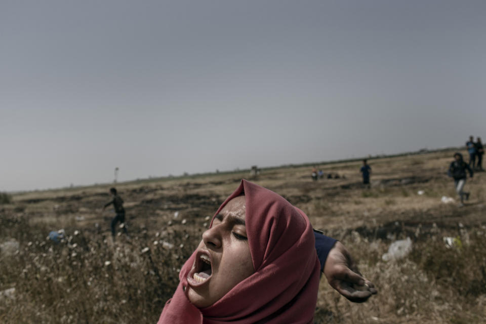 <p>A Palestinian woman throws a stone toward Israeli troops during the “Great March of Return” protests at the Eastern Gaza City’s border with Israel on April 13, 2018. (Photo: Fabio Bucciarelli for Yahoo News) </p>