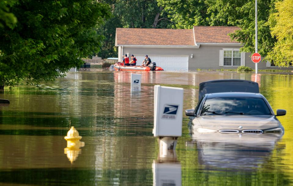 Sioux City Fire Rescue uses a boat to retrieve medical devices from a home in the flooded Riverside neighborhood of Sioux City, Tuesday, June 25, 2024.