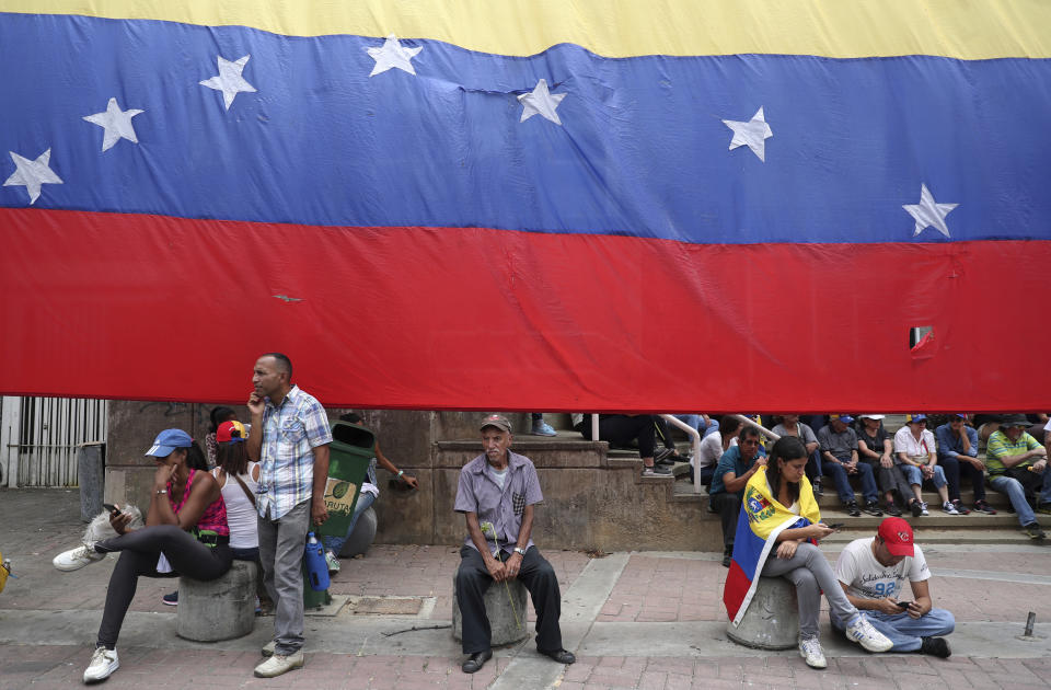 Opponents of the Nicolas Maduro government wait for the arrival of opposition leader Juan Guaidó to lead a rally in Caracas, Venezuela, Saturday, May 11, 2019. Guaidó has called for nationwide marches protesting the Maduro government, demanding new elections and the release of jailed opposition lawmakers. (AP Photo/Martin Mejia)