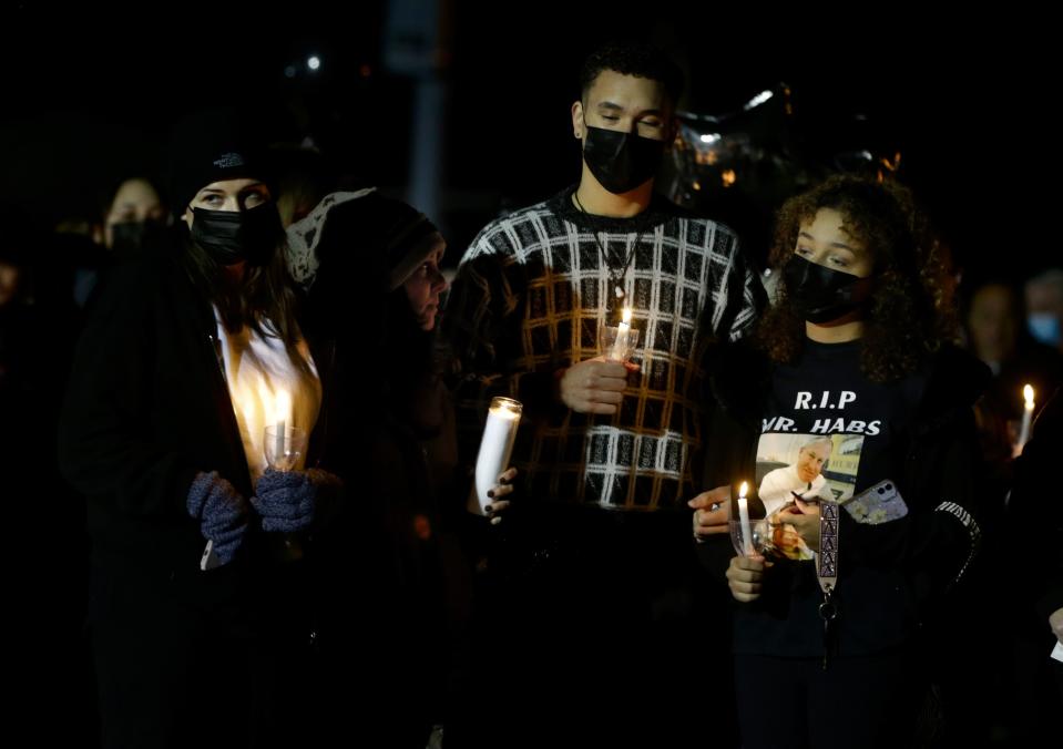 A few hundred people gathered at the Pilgrim High School football field on Sunday evening for a candlelight vigil to pay tribute to principal Gerald Habershaw.