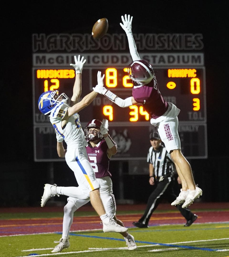Harrison's Joe Crupi (1) breaks up a pass intended for Mahopac's Quentin Bally (20) during their 18-0 win over Mahopac in Class A quarterfinal football action at Harrison High School in Harrison on Friday, October 27, 2023.