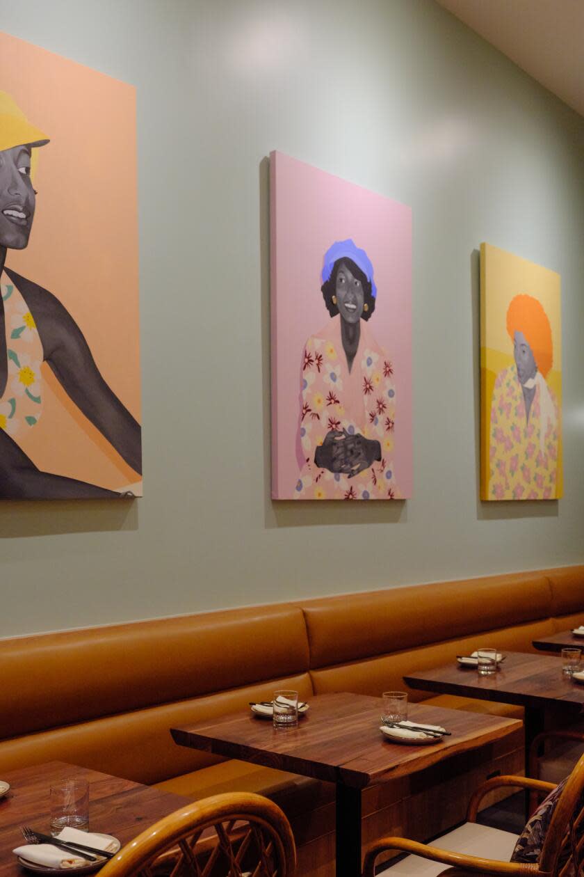 Joyce's dining room, with three portraits on the wall of a woman in different ages and fashion eras of her life. 