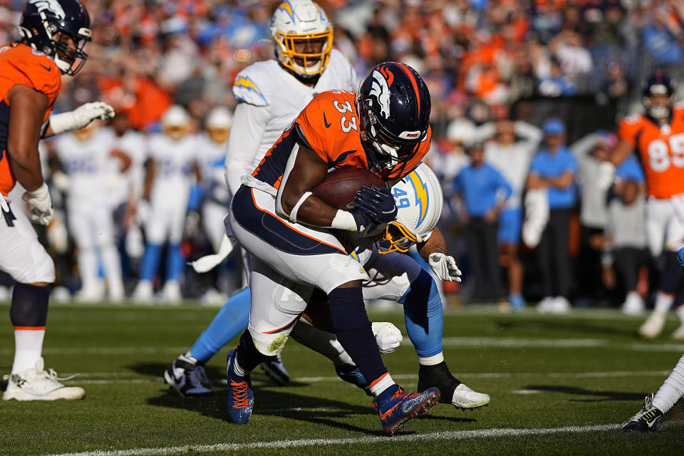 Denver Broncos running back Javonte Williams (33) scores a touchdown against the Los Angeles Chargers during the first half of an NFL football game, Sunday, Nov. 28, 2021, in Denver. (AP Photo/Jack Dempsey)