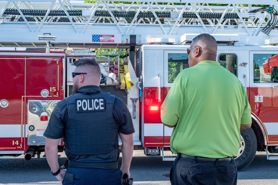 Byesville Police Chief Daulton Dolan and Mayor Jay Jackson watch the Firemen's Festival parade as it makes its way down Route 209.