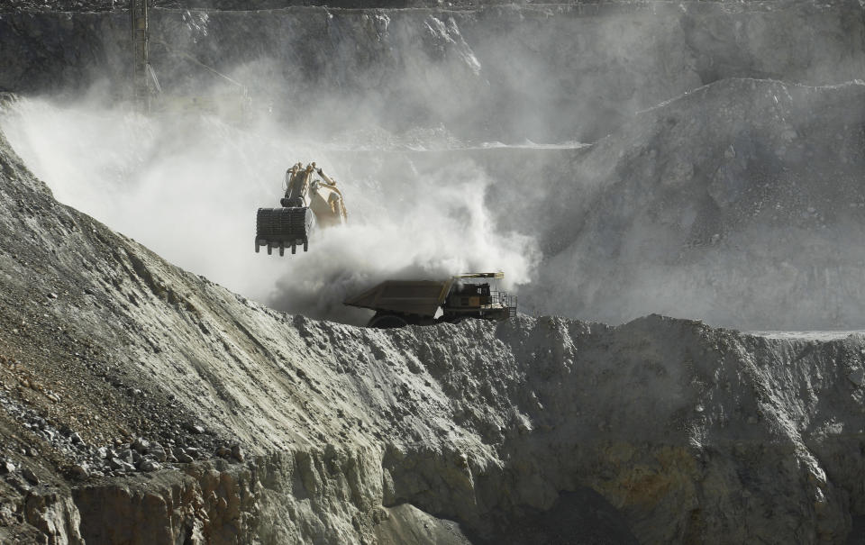 In this Sept. 25, 2012 photo, a bulldozer works at the Chuquicamata copper mine in the Atacama desert in northern Chile. Experts say that by 2019 the Chuquicamata copper mine will be unprofitable, so state-owned mining company Codelco is trying to head off closure by converting the open pit into the world's largest underground mine. Codelco believes the mine still has much more to give, with reserves equal to about 60 percent of all the copper exploited in the mine's history still buried deep beneath the crater. (AP Photo/Jorge Saenz)