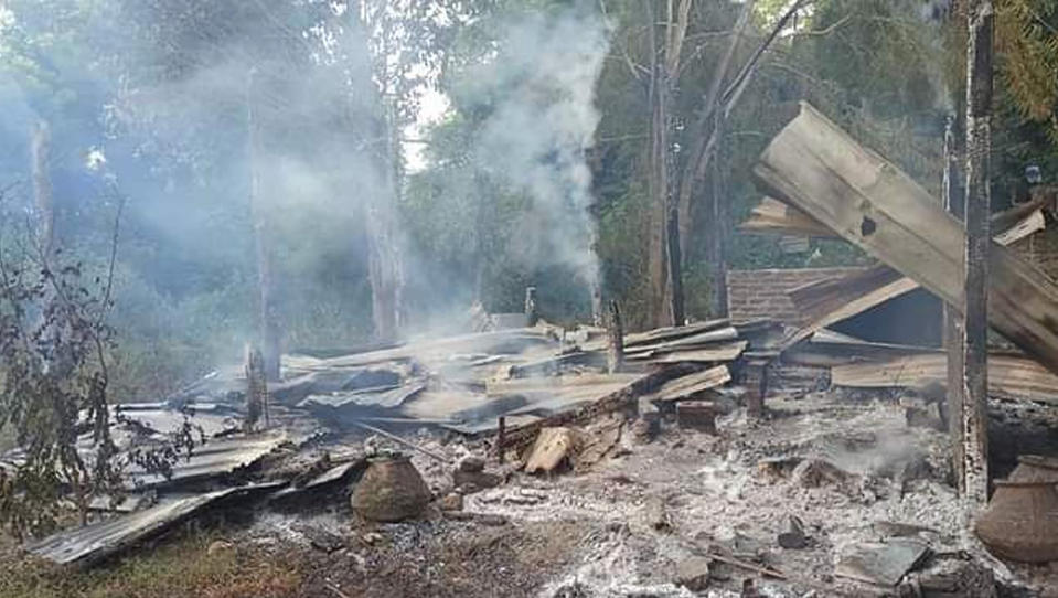 Smoke rises from debris and corrugated roofing of a school structure that was burned to the ground in Taung Myint village in the Magway region of Myanmar on Sunday, Oct. 16, 2022. The decapitated body of a volunteer teacher in rural Myanmar was found on grotesque display at a village school after he was detained and killed by the military, witnesses said Thursday, Oct. 20, 2022. (AP Photo)