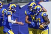 Los Angeles Rams' Darrell Henderson, right, celebrates his touchdown with quarterback Matthew Stafford, left, and Cooper Kupp, second from right, during the first half of an NFL football game against the New York Giants, Sunday, Oct. 17, 2021, in East Rutherford, N.J. (AP Photo/Frank Franklin II)