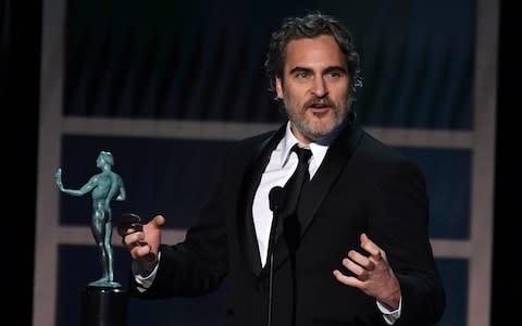 US actor Joaquin Phoenix accepts the award for Outstanding Performance by a Male Actor in a Leading Role during the 26th Annual Screen Actors Guild Awards - Credit: AFP