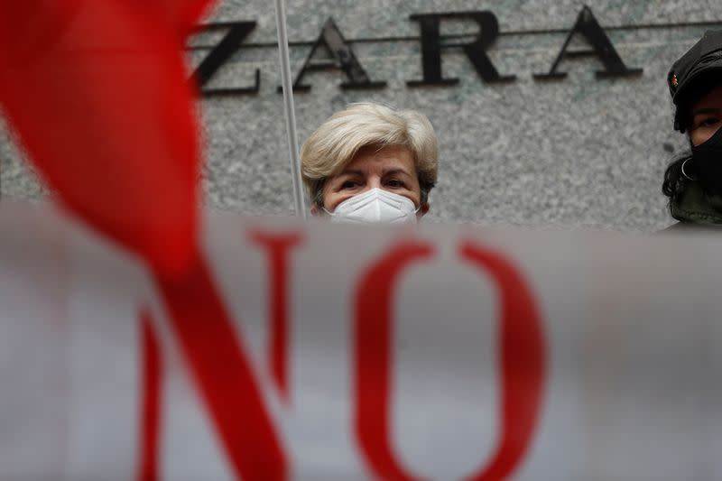 People protest outside a Zara clothing store in Madrid