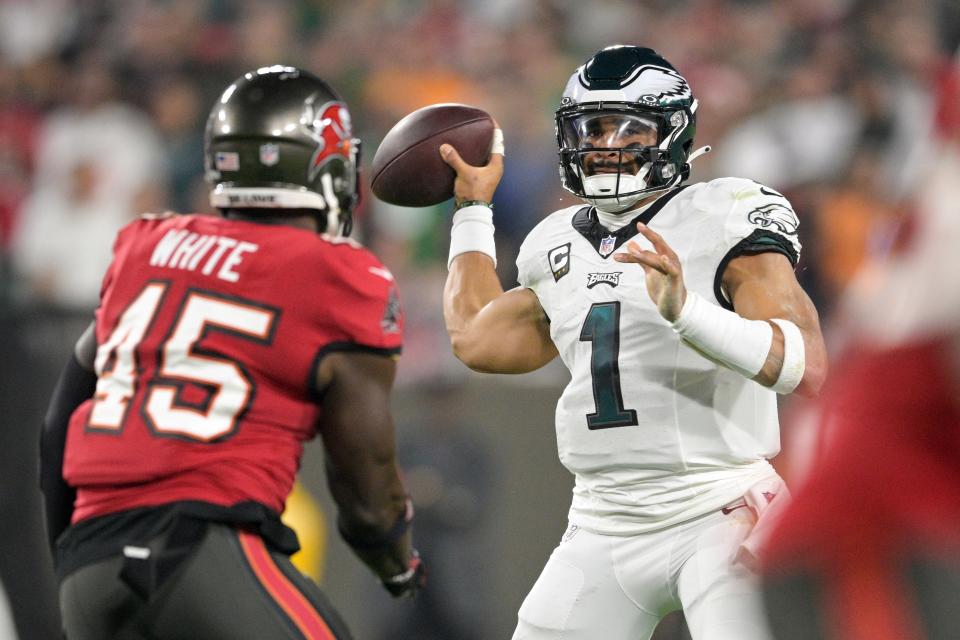 Philadelphia Eagles quarterback Jalen Hurts (1) looks to pass as Tampa Bay Buccaneers linebacker Devin White (45) rushes in during the first half of an NFL wild-card playoff football game, Monday, Jan. 15, 2024, in Tampa, Fla.