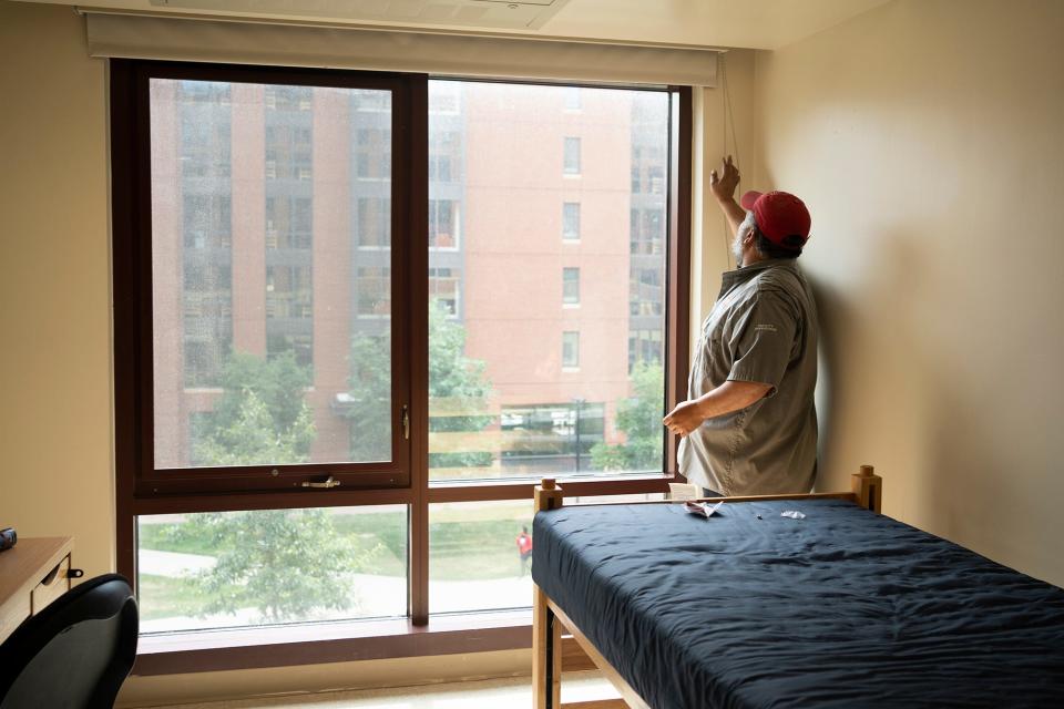 Anthony Navarro, on Ohio State's operations crew, works to clean and repair dorms for new students come fall semester.