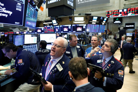 Traders work on the floor of the New York Stock Exchange (NYSE) in New York, U.S., October 23, 2018. REUTERS/Brendan McDermid