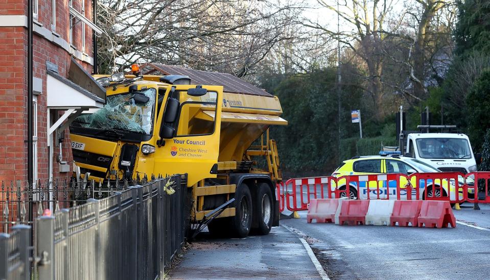 A gritter crashed into a house in Chester Road, Helsby, Cheshire, early on Monday. The road was closed entirely while the site was cleared. (PA).