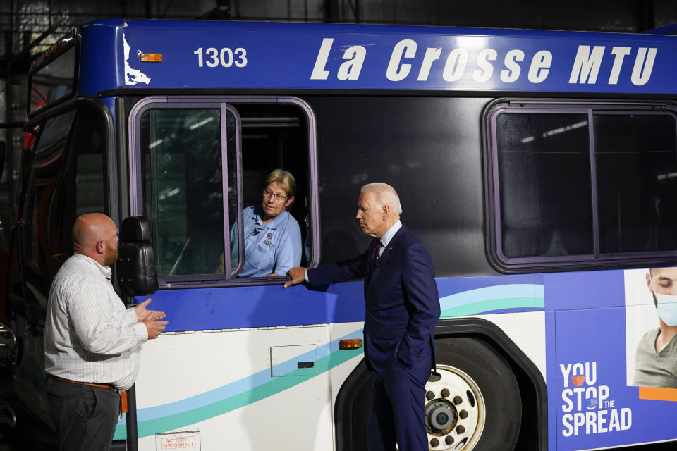 President Joe Biden participates in a tour of the La Crosse Municipal Transit Authority with Adam Lorentz, Transit Manager, La Crosse Municipal Transit Utility, left, and Laurie Nederloe, bus driver for La Crosse MTU, Tuesday, June 29, 2021, in La Crosse, Wis. (AP Photo/Evan Vucci)