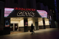 A shopper walks past a closed AMC movie theater Thursday, Nov. 19, 2020, in Santa Monica, Calif. California Gov. Gavin Newsom is imposing an overnight curfew as the most populous state tries to head off a surge in coronavirus cases. On Thursday, Newsom announced a limited stay-at-home order in 41 counties that account for nearly the entire state population of just under 40 million people. (AP Photo/Marcio Jose Sanchez)