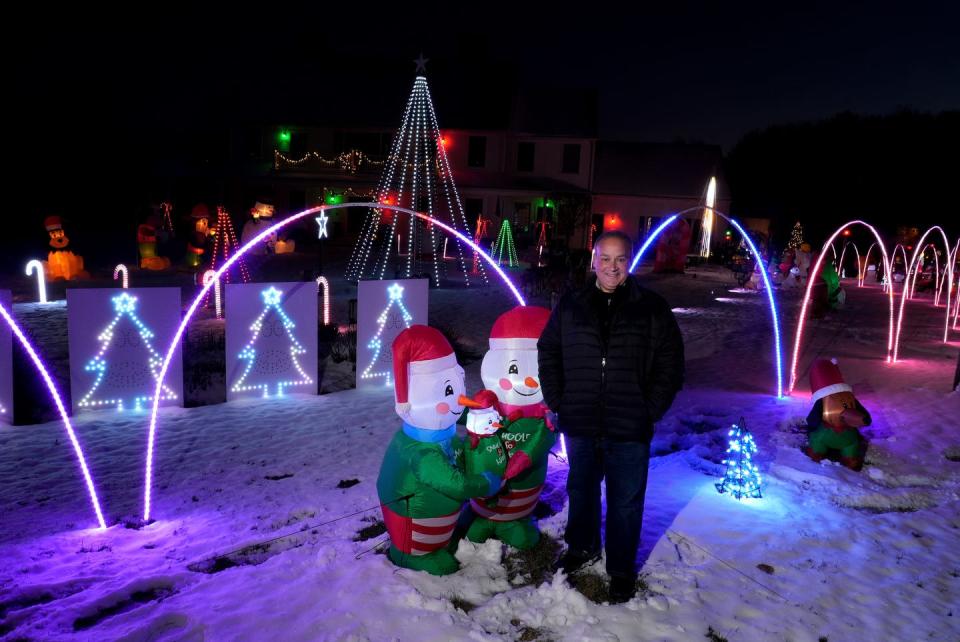 Anthony Gemma stands in just a small section of the holiday display of lights and inflatables that encompass his Exeter property. 