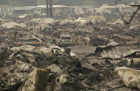 <p>A car sits in the middle of property destroyed from fires at Journey’s End mobile home park in Santa Rosa, Calif., Tuesday, Oct. 10, 2017. (Photo: Jeff Chiu/AP) </p>