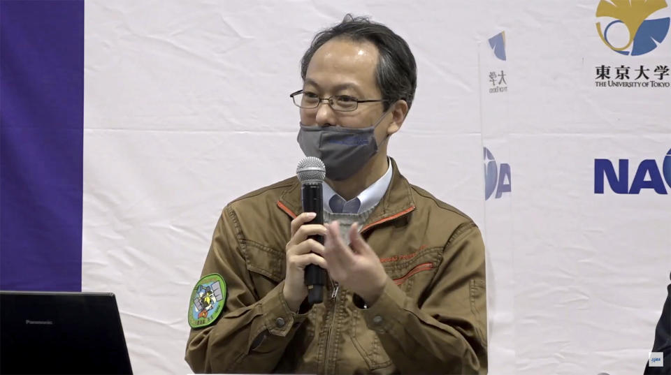 In this image made from youtube video provided by JAXA, its project manager Yuichi Tsuda speaks during a press conference in Sagamihara, near Tokyo, Friday, Dec. 4, 2020. The Japanese space agency said Friday they are all set for its spacecraft′s final approach to Earth this weekend to deliver a capsule containing valuable samples of a distant asteroid that could provide clues to the origin of the solar system. (JAXA via AP)