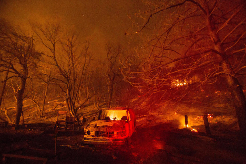 A burned vehicle is seen in the Lake Hughes fire in Angeles National Forest on Thursday, August 13, 2020, north of Santa Clarita, California.  / Credit: Ringo H.W. Chiu/AP