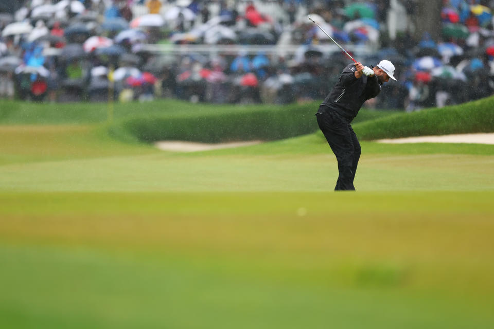 Jon Rahm plays a chip at the 2023 PGA Championship