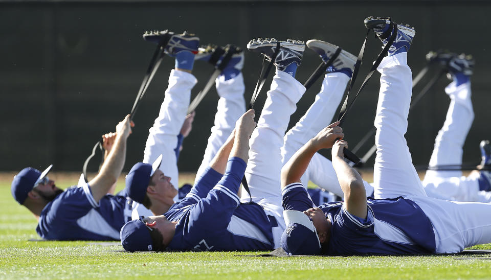 Los Angeles Dodgers pitchers stretch during spring training baseball practice Tuesday, Feb. 11, 2014, in Glendale, Ariz. (AP Photo/Paul Sancya)