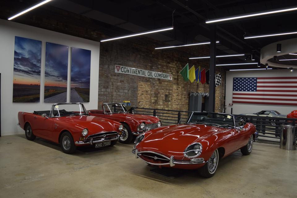 Three convertible cars sit in a corner of The Garage during the Going Tops Down exhibit. Included in the European section of the exhibit is a right-hand drive Sunbeam Alpine imported from Britain and a Jaguar XK-E that has been in central Kansas for its lifetime.