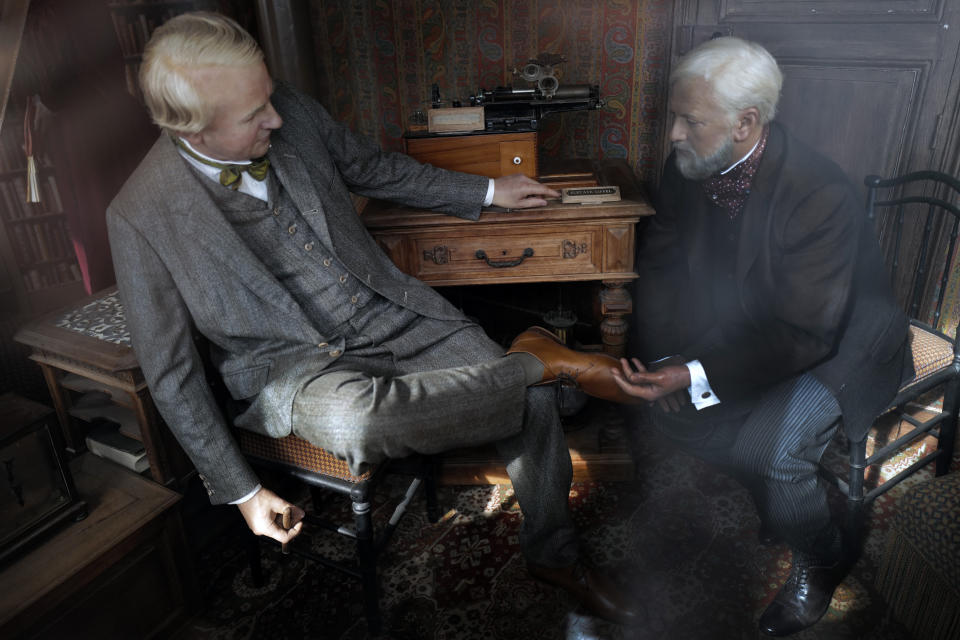 Wax sculptures shows the visit of US physicist and inventor Thomas Edison, left, on September 10th, 1889, with French architect Gustave Eiffel, right, displayed in a small room on the third level during the opening up of the top floor of the Eiffel Tower, in Paris, Wednesday, July 15, 2020. The top floor of Paris' Eiffel Tower reopened today as the 19th century iron monument re-opened its first two floors on June 26 following its longest closure since World War II. (AP Photo/Francois Mori)