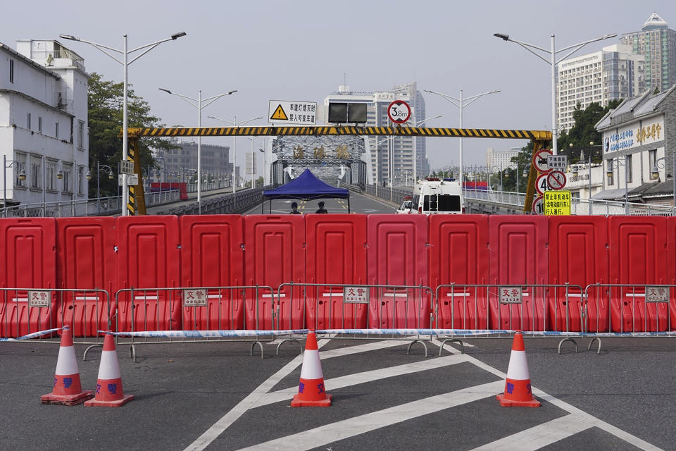 Barriers form a security checkpoint in the Haizhu district in Guangzhou in southern China's Guangdong province Friday, Nov. 11, 2022. As the country reported 10,729 new COVID cases on Friday, more than 5 million people were under lockdown in the southern manufacturing hub Guangzhou and the western megacity Chongqing. (AP Photo)