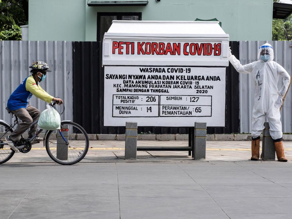 Statistics for COVID-19 coronavirus infection and deaths displayed with a coffin and a mannequin wearing personal protective equipment installation in the local area of Jakarta. PHOTOGRAPH BY Feature China / Barcroft Studios / Future Publishing (Photo credit should read Feature China/Barcroft Media via Getty Images)