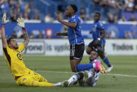 CF Montreal forward Mason Toye, center, watches his shot go past diving Minnesota United goalkeeper Dayne St. Clair, left, as Minnesota United defender D.J. Taylor, right, attempts a tackle during first-half MLS soccer match action in Montreal, Saturday, June 10, 2023. (Evan Buhler/The Canadian Press via AP)