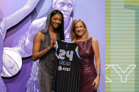 LSU's Angel Reese, left, poses for a photo with WNBA commissioner Cathy Engelbert after being selected seventh overall by the Chicago Sky during the first round of the WNBA basketball draft on Monday, April 15, 2024, in New York. (AP Photo/Adam Hunger)