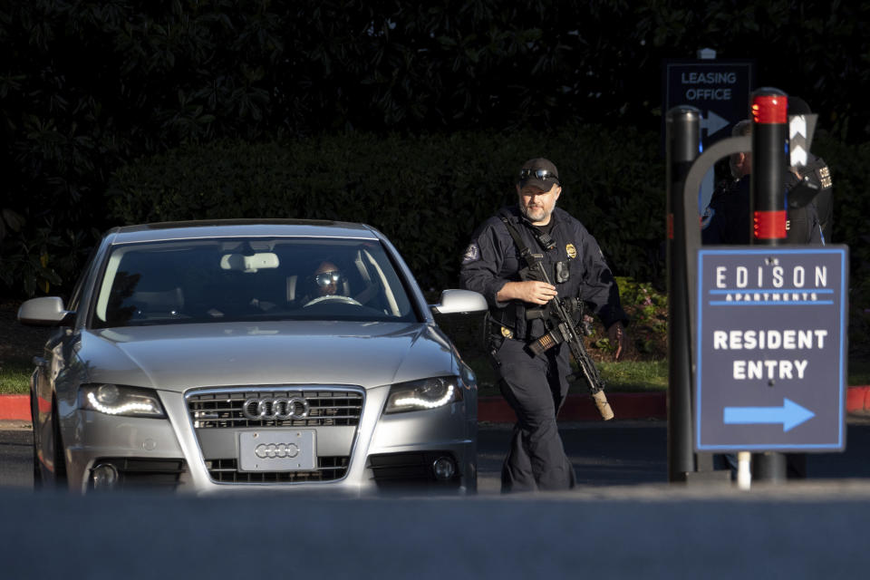 Cobb County Police search cars as they leave the Edison Apartments in Smyrna, Ga., Wednesday, May 3, 2023, after a shooter killed one person and injured four others in a medical building in Atlanta, then was seen on a traffic camera in the area. (AP Photo/Ben Gray)