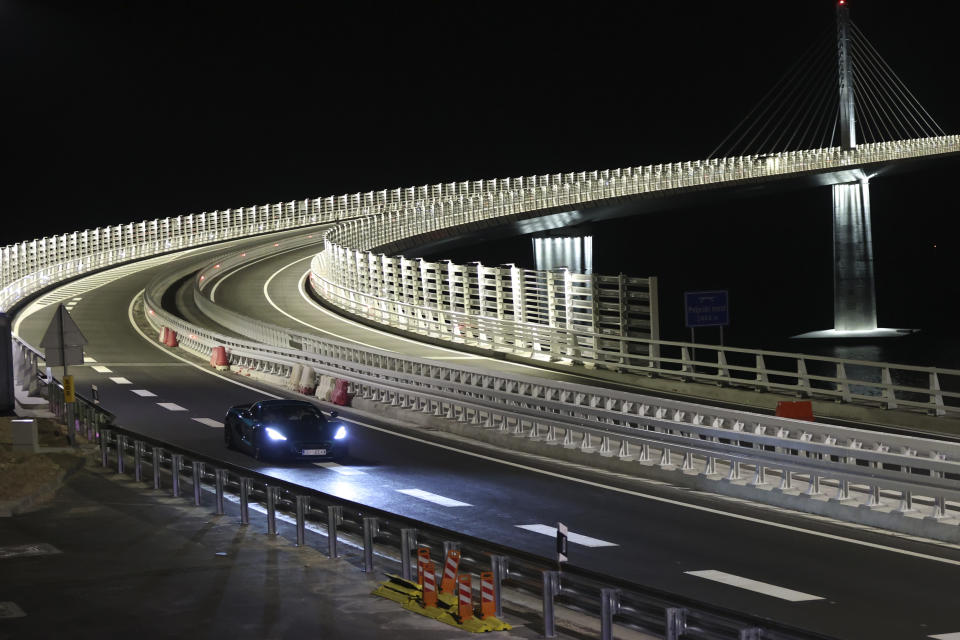 A Croatian made 'Nevera' electric car drives on the newly built Peljesac Bridge in Komarna, southern Croatia, Monday, July 25, 2022. Croatia is marking the opening of a key and long-awaited bridge connecting two parts of the country's Adriatic Sea coastline while bypassing a small part of Bosnia's territory. (AP Photo)