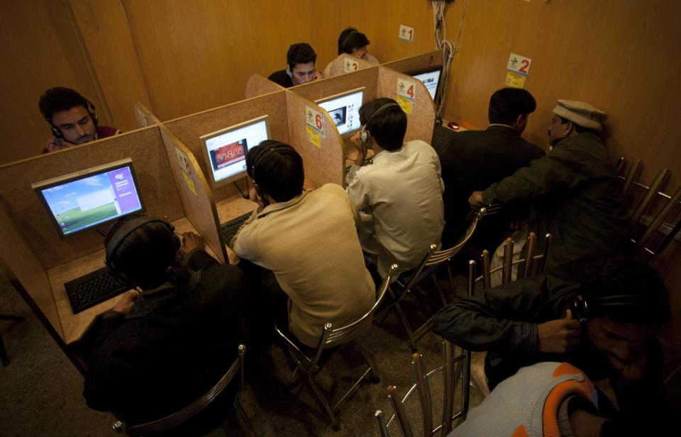 In this photo taken Wednesday, March 7, 2012, people use the Internet at a local cafe in Islamabad, Pakistan. Pakistan wants to install an Internet filtering system capable of blocking 50 million Web pages - and doesn't mind advertising the fact. The plan is alarming free speech activists who fear current censorship could become much more widespread. (AP Photo/B.K. Bangash)