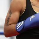A tattoo that reads "Queen" is seen on the right arm of United States' 60-kg lightweight boxer Queen Underwood during a practice session at the 2012 Summer Olympics, Thursday, July 26, 2012, in London. (AP Photo/Patrick Semansky)