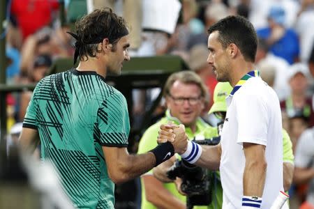 Mar 28, 2017; Miami, FL, USA; Roger Federer of Switzerland (R) shakes hands with Roberto Bautista Agut of Spain (R) after their match on day eight of the 2017 Miami Open at Crandon Park Tennis Center. Mandatory Credit: Geoff Burke-USA TODAY Sports