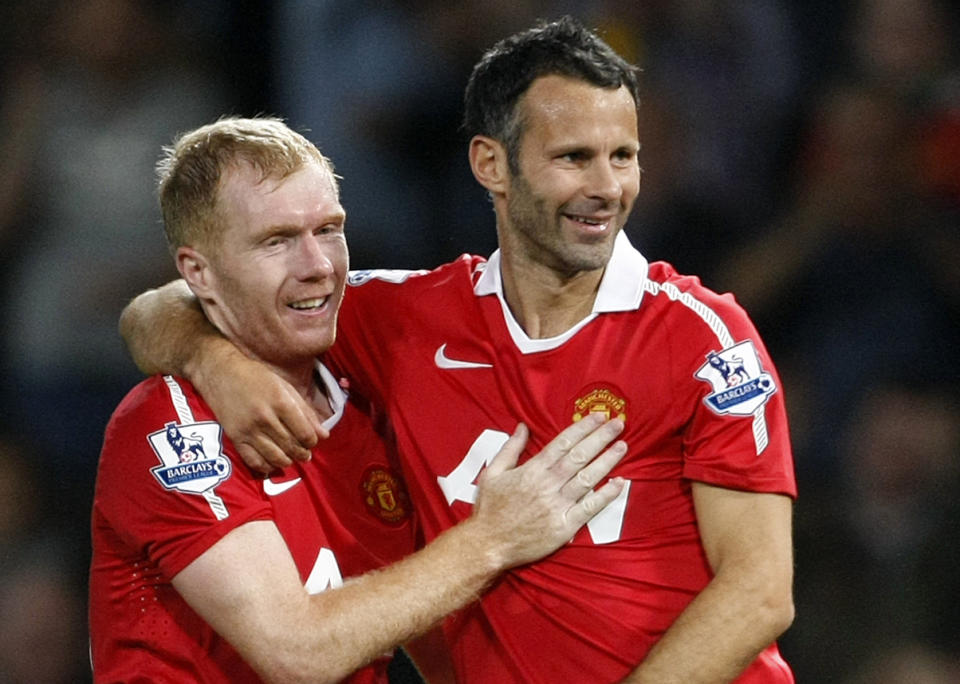 FILE - This is a Monday, Aug. 16, 2010 file photo Manchester United's Ryan Giggs, right, with teammate Paul Scholes after scoring a goal against Newcastle United during their English Premier League soccer match at Old Trafford, Manchester, England. Ryan Giggs will be assisted by former teammates Paul Scholes, Nicky Butt and Phil Neville during his spell as interim manager of Manchester United following the dismissal of David Moyes. (AP Photo/Tim Hales, File)