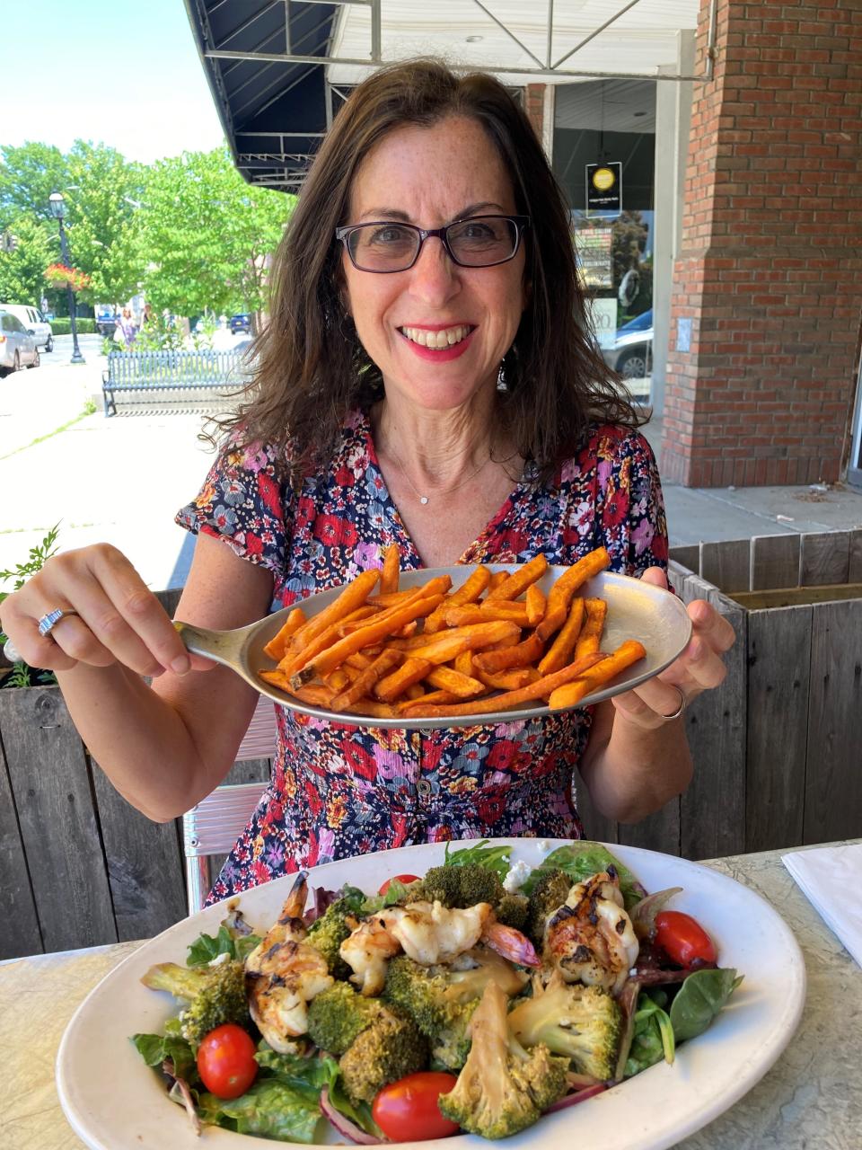 Lohud Food & Dining Reporter Jeanne Muchnick with her fave sweet potato fries at Horsefeathers in Tarrytown. Photographed June 2022.