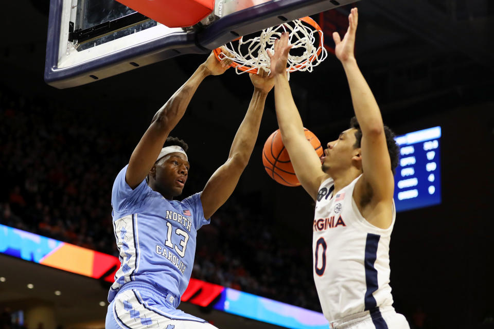 CHARLOTTESVILLE, VA – JANUARY 10: Jalen Washington #13 of the <a class="link " href="https://sports.yahoo.com/ncaab/teams/n-carolina/" data-i13n="sec:content-canvas;subsec:anchor_text;elm:context_link" data-ylk="slk:North Carolina Tar Heels;sec:content-canvas;subsec:anchor_text;elm:context_link;itc:0">North Carolina Tar Heels</a> dunks over Kihei Clark #0 of the Virginia Cavaliers in the first half during a game at John Paul Jones Arena on January 10, 2023 in Charlottesville, Virginia. (Photo by Ryan M. Kelly/Getty Images)