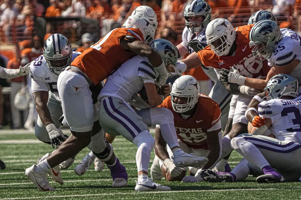 Kansas States quarterback Avery Johnson (5) is tackled by Texas linebacker Jaylan Ford (41) during their game at Royal-Memorial Stadium on Saturday, Nov. 4, 2023 in Austin.